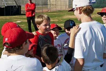 A huddle of laughing campers in red caps